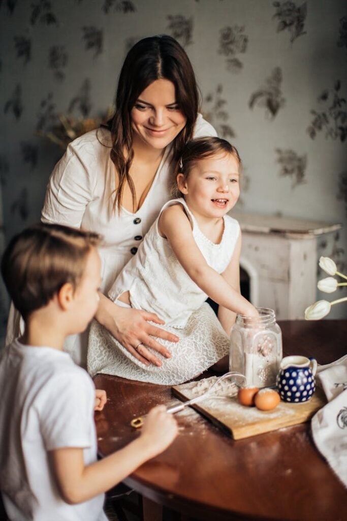 Happy mother and kids enjoying a baking session in a cozy kitchen setting.